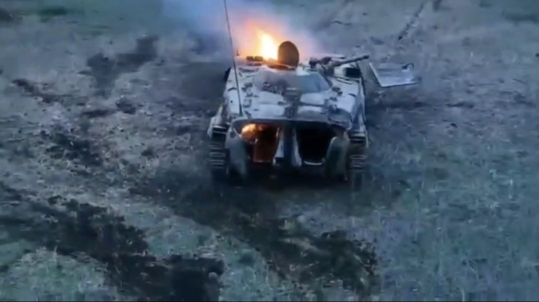 Russian soldiers are hiding under destroyed and burning armored personnel carrier